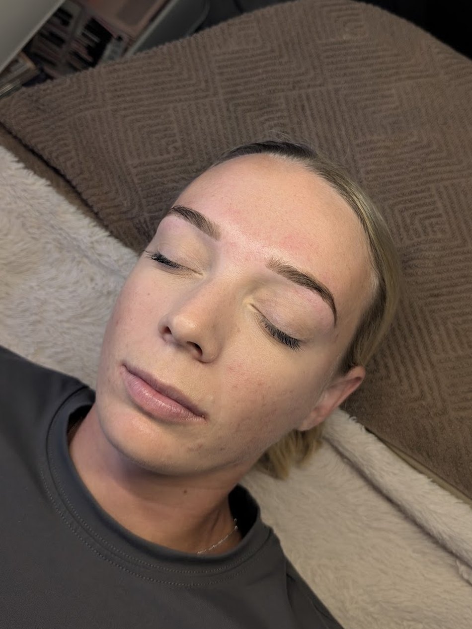 A client relaxing with softly shaped, freshly lifted brows